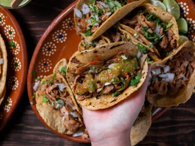 Person holding a Mexican street taco